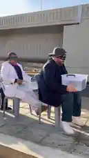 In this comedic outdoor prank, several men sit blindfolded on chairs beside a road under an overpass. Each man holds a clear plastic bucket filled with water. One by one, they are surprised as someone off-camera dumps ice-cold water over their heads, causing them to scream, laugh, and react with shock. It's a classic 'water bucket challenge' turned into a hilarious public prank. by @elqaq with Original Sound by elqaq
