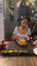 In this short, engaging clip, Tiny Benzy sits at a table with a basket of tortilla chips and a variety of colorful dips. She uses a spoon to try different sauces, showcasing her reactions as she tastes them. The scene captures a fun and casual food tasting moment, perfect for anyone interested in quick food challenges or snack ideas. by @tinybenzy1 with Original Sound by tinybenzy1