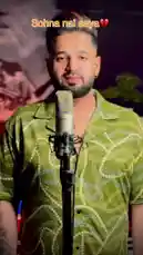 In this captivating live performance, singer Gunkaar delivers a heartfelt rendition of his song 'Sohna Nai Aaya'. Dressed in a vibrant green patterned shirt, he sings passionately into a studio microphone, his expressive gestures and soulful delivery conveying deep emotion. The intimate setting, highlighted by warm lighting and a large artistic backdrop, creates an authentic atmosphere perfect for appreciating the raw talent and connection to the music. by @real_gunkaar with real_gunkaar by Original Sound