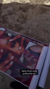 This video provides a close-up, step-by-step view of a person unrolling a promotional banner for 'Beauty Plus Studio.' The banner features images of manicured hands and lists services such as Nails, Pedicures, Lashes, Piercings, and Tattoos. The camera follows the banner as it unfurls across a concrete floor, offering a clear look at the design and layout of the advertisement. by @naa.ayele911 with Don't Play With Me by Gabzy