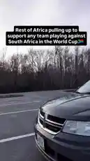 A man in a car, wearing a fur-lined jacket, passionately sings along to music while driving. Text overlay reads 'Rest of Africa pulling up to support any team playing against South Africa in the World Cup,' highlighting a moment of continental unity during a major football event. by @be-sassyish with Original Sound by Contains: Soul Glo Intro - Dock Winters