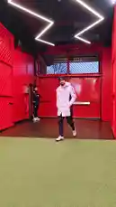 A behind-the-scenes look as Manchester United players walk through their training facility. They are seen arriving in team tracksuits and jackets, passing by the iconic club crest on the red walls before heading into the team area. by @manutd with Original Sound by manutd