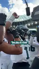 A close-up view of Philadelphia Eagles players gathered in a pre-game huddle, showing intense focus and team unity. A player wearing jersey number 86 is prominently featured, listening intently as a teammate speaks. The atmosphere is charged with anticipation, capturing the essence of sportsmanship and determination before a crucial match. by @eagles with Original Sound by eagles