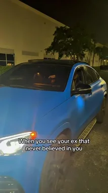 A young man celebrates his success after being doubted by his ex-partner. He shows off his new car and watch, then dances triumphantly in a parking lot as his ex watches in disbelief. by @itz.miirah with Original Sound by itz.miirah