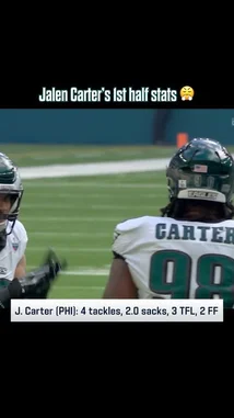This video highlights Philadelphia Eagles defensive tackle Jalen Carter's impressive first-half performance against the Jaguars. On-screen text details his stats: 4 tackles, 2.0 sacks, 3 tackles for loss (TFL), and 2 forced fumbles. The footage shows Carter interacting with teammates Baun and another player on the field, capturing a moment from the game. by @eagles with Original Sound by eagles