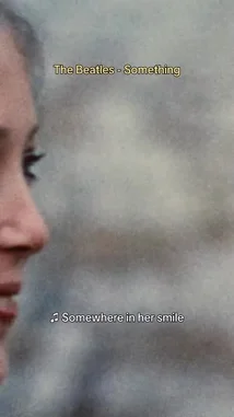 A nostalgic look at The Beatles' iconic song 'Something,' featuring close-up shots of band members John Lennon and Paul McCartney, alongside scenes of a couple in a garden. The video includes lyrics from the song, capturing the romantic and timeless essence of the classic track. by @thebeatles with Something (2019 Mix) by The Beatles