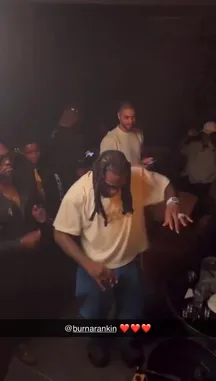 This exclusive behind-the-scenes look captures SPINALL at a vibrant, dimly lit party. The scene is filled with energy as he dances enthusiastically with friends, smoke swirling in the air, and drinks on a nearby table. The atmosphere is electric, showcasing a candid moment of celebration and camaraderie. by @djspinall with djspinall by Original Sound