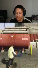 Watch Jayify's real-time reaction as he plays Grand Theft Auto V. The gameplay unfolds from an explosive tank scene to a tense moment inside a house where his character makes a phone call, all captured in a split-screen format showing the player and the game. by @jayify5 with Original Sound by jayify5