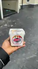 Giftedonye🦋 showcases Aga's Parfait, a zero-fat yogurt product, held in hand against a paved outdoor backdrop. The container features a colorful label with 'ZERO FAT' and 'FRESH SALAD' clearly visible, suggesting a healthy snack option. by @giftedonye22 with giftedonye22 by Original Sound