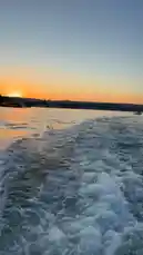 Experience the breathtaking beauty of a sunset cruise on the Bosphorus Strait in Istanbul. This scenic journey captures the golden hour glow reflecting off the water, the wake of the boat trailing behind, and the city skyline illuminated by the setting sun. It's a perfect example of capturing serene travel moments. by @n.c7x with Original Sound by n.c7x