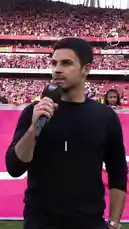 Witness a pivotal moment in Arsenal Football Club's history. A player, speaking passionately to the crowd on May 19, 2024, delivers a powerful message: 'Don't be satisfied. Because we want much more.' The scene then transitions to a triumphant celebration on May 24, 2026, where the same player, now wearing a 'CHAMPIONS' jersey, lifts the Premier League trophy aloft amidst confetti and roaring fans. This video encapsulates the journey from determination to ultimate victory. by @premierleague with Original Sound by premierleague