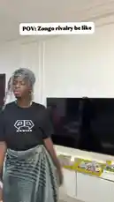 A comedic skit portraying a fictional rivalry between two street vendors named 'Zongo' and 'Muktar'. The video uses exaggerated expressions and dialogue to humorously depict their competitive dynamic. One character, dressed in a black t-shirt and headwrap, confronts another character, who is wearing a white tank top and red headwrap, questioning his identity and challenging him to a confrontation. The skit includes humorous text overlays like 'Which fool is the waakye seller?' and 'I am stronger than you.' This short-form comedy piece is presented in a relatable, everyday setting, showcasing the playful tension between the characters. by @itz.miirah with Original Sound by itz.miirah