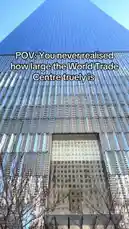 This short clip uses a point-of-view shot to dramatically showcase the immense scale of the World Trade Center. It begins with a ground-level perspective, then tilts upwards to reveal the towering glass facade of one of its iconic skyscrapers against a clear blue sky, emphasizing its massive size. by @uk-gos with Original Sound by uk-gos
