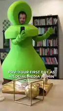 A man in a bright green, full-body costume resembling a chess piece stands in a room with a bookshelf. He holds a smartphone and gestures with his hands, looking around with a slightly bewildered expression. The text overlay reads 'POV: YOUR FIRST DAY AS A SOCIAL MEDIA ADMIN'. The camera zooms in on his face as he continues to look around. by @chesscom with Original Sound by Contains: End of Beginning - Djo