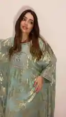 Watch as a model showcases a stunning light green kaftan dress with intricate gold embroidery and silver embellishments. She turns slowly to display the full silhouette, back details, and flowing fabric, offering a complete look at this beautiful outfit. by @needle_t with original sound