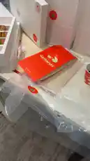 This video provides a behind-the-scenes look at a GatherUS food delivery. It features a close-up of their branded packaging, a perfectly poured coffee being served into a branded cup, and a detailed view of a delicious-looking box filled with fresh croissant sandwiches. The entire experience highlights the quality and presentation of the meal. by @guruofmarketing with Original Sound by guruofmarketing