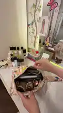 A woman demonstrates her travel hack for packing a Dyson hair dryer. She shows how she uses a dedicated, patterned pouch to neatly store her blow dryer and accessories, making it easy to pack for trips with friends. by @moneeragh with Original Sound by moneeragh