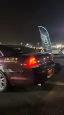 In a stunning display of automotive power, M performs a dramatic burnout in a maroon Chevrolet Impala during a nighttime event celebrating Saudi National Day. The car's tires screech against the pavement, filling the air with thick smoke as the engine roars. This high-octane performance captures the spirit of car culture and national pride. by @mo_kbs8 with Original Sound by mo_kbs8