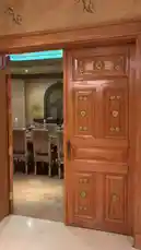 Experience the elegance of a professionally prepared buffet by نجوم المستوى لتنظيم الحفلات. This high-end catering setup features a stunning wooden door entrance leading to a beautifully arranged dining room with ornate details. The camera then focuses on a long buffet line with multiple stainless steel chafing dishes filled with a variety of hot meals, including seafood, rice dishes, and other gourmet options. A staff member in white attire and black gloves meticulously arranges the food, ensuring everything is perfectly presented and ready for guests. The overall atmosphere exudes sophistication and attention to detail, ideal for a formal event. by @levelstars7 with Original Sound by levelstars7