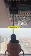 A behind-the-scenes look at a fitness coach from Active Circle during a workout session. The individual, wearing a brown 'COACH' shirt, is seen using an elliptical machine overlooking a sprawling cityscape. This moment captures dedication and routine, blending personal fitness goals with an urban environment. by @activecircle with original sound
