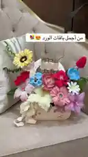 This charming video showcases a beautifully crafted crochet flower basket gift set from متجر ريزن تبوك. The arrangement features a vibrant mix of colorful crocheted flowers—including sunflowers, tulips, gerberas, and lilies—nestled in a decorative basket alongside a small bottle of perfume or lotion. A delicate white ribbon adds a final touch of elegance. The entire piece is presented on a stylish tufted sofa, highlighting its potential as a thoughtful handmade present. by @r200an with original sound