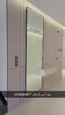 This walkthrough video presents a beautifully designed modern entryway by Zood Asas Decoration. The space features a sleek, full-length mirror with a black frame, a minimalist floating shelf, stylish black coat hooks, and integrated lighting. The clean lines, neutral color palette, and contemporary hardware create a sophisticated first impression. The video highlights the craftsmanship and attention to detail in this elegant home decor installation. by @zoodasas with Original Sound by zoodasas