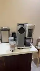 A person demonstrates using a Ninja coffee maker system. They show a blender cup filled with a blended mixture, then place it into the machine, preparing to make a drink. by @alysf90 with Original Sound by alysf90