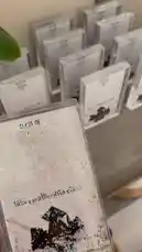 A close-up showcase of personalized graduation gifts for the Class of 2026. The clear acrylic frames feature a glittery design with silhouettes of graduates, the text 'CLASS OF 2026', and Arabic script that translates to 'We have graduated with pride'. Multiple identical frames are displayed, suggesting they are ready for distribution as commemorative keepsakes. by @rubaaomaar with Original Sound by Contains: Ya Hala Belhilm - Humood AlKhudher