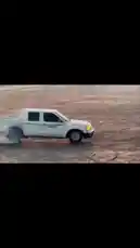 In this high-energy clip, a white pickup truck, driven by فيصل 🥷🏻F, performs dramatic donuts and drifts across a cracked, dusty surface. Tire smoke billows as the vehicle executes precise circular maneuvers, showcasing impressive control. The setting appears to be a large, open lot or arena, possibly for a stunt show or demonstration. by @zf_v81 with Original Sound by zf_v81