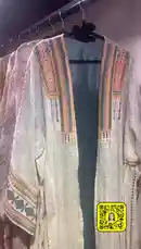 Explore a stunning collection of intricately embroidered dresses and fashionable garments hanging on display racks. This curated selection features a variety of styles, colors, and embellishments, including delicate beading, floral patterns, and elegant silhouettes. A hand gently touches one of the garments, highlighting the fine craftsmanship and luxurious fabrics. The setting appears to be a boutique or a personal wardrobe, showcasing the artistry behind each piece. by @needle_t with needle_t by Contains: موسيقى عربية اصيلة موسيقى البيات رائعة - EchoWave