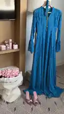 A tour of a luxurious hotel bathroom and living area, showcasing a bubble bath, a large bouquet of pink roses, and a vanity with Dior beauty products. The scene transitions to a coffee and chocolate tasting experience, highlighting Royal Nourish perfumes and elegant table settings. by @bee.8907 with Original Sound by bee.8907