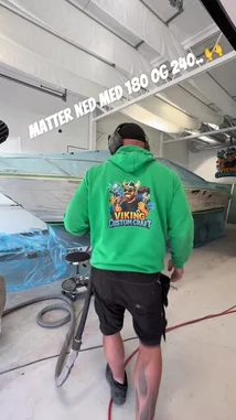 Watch a professional detailer from Viking Custom Craft meticulously prepare a boat for painting inside a workshop. The process involves removing protective plastic sheeting and using a rotary tool to sand down the hull's surface, demonstrating a key step in boat restoration and detailing. by @vikingcustom with F’n Friday by Contains: F'n Friday - COLTER RAYNE