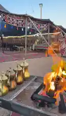 Experience the warm ambiance of an evening gathering at Kaizen Rawaqa. This scene captures traditional brass coffee pots being warmed over a crackling campfire, alongside a platter of fresh yellow fruits. The setting, adorned with patterned textiles under a large tent, evokes a sense of cultural celebration and community. by @nouf4445 with nouf4445 by Original Sound