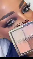 Watch آزهار المنوآشي💄 demonstrate her glamorous makeup look, featuring bold brows, shimmering gold eyeshadow, and voluminous lashes. She showcases a Dior highlighter palette, highlighting the brand's role in creating a radiant, high-fashion finish. by @azhron1234 with original sound