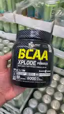 A close-up look at Olimp Sport Nutrition's BCAA Xplode Powder and their R-Weier Zero Focus & Energy drink. The video showcases the product packaging details, including the 'Black Series' branding and nutritional information, while also displaying large quantities of the green and blue cans. by @lanutritioniraq with Original Sound by lanutritioniraq