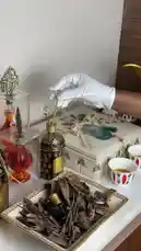 In this elegant unboxing, Ebtihaj Al-Mutairi presents a beautifully arranged collection of traditional Arabian items. A gloved hand carefully opens a palm tree-patterned gift box, revealing a stunning array of ornate perfume bottles with crystal stoppers, a golden Arabic coffee pot, and a tray of fragrant agarwood chips. The scene then shifts to reveal a large box filled with fresh dates, accompanied by two small patterned cups of tea, all set against a sophisticated modern backdrop. This curated display highlights luxury, tradition, and hospitality. by @bee.8907 with Original Sound by bee.8907