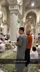 This video offers an immersive tour inside one of the world's most magnificent mosques. Viewers are taken through vast prayer halls filled with worshippers dressed in traditional white garments, seated on ornate green carpets. The architecture is breathtaking, featuring towering white marble columns, intricate arches, and elaborate ceiling designs illuminated by grand chandeliers. The atmosphere is one of profound peace and devotion, capturing a moment of collective worship in a space of immense beauty. by @om-5p with Original Sound by om-5p