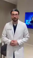 Plastic Surgeon Dr. M. Almarghoub speaks directly to the camera, summarizing three recent cosmetic surgeries performed under local anesthesia. He thanks his patients for their trust and details the procedures: upper eyelid surgery, fat removal from the chin area with jawline definition, and correction of prominent ears. by @dralmarghoub with Original Sound by dralmarghoub