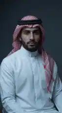 A man dressed in traditional Saudi attire, including a white thobe and red-and-white checkered ghutra, is shown in a close-up portrait. The scene transitions to him seated on an ornate golden throne, surrounded by scattered currency, with the date '15.7.2026' displayed. The Arabic voiceover adds a narrative element, suggesting themes of legacy and future leadership. by @dotmedia.sa with Original Sound by dotmedia.sa