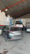 Step into the bustling world of Wasta Hawkar Service, a professional auto repair garage. This behind-the-scenes look shows mechanics at work, vehicles on lifts, and customers interacting, all under the expansive roof of a busy workshop. by @hawkar_service with Original Sound by hawkar_service