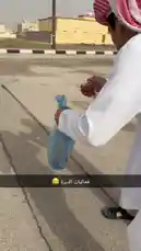This video shows a person in traditional white clothing preparing and lighting a small firecracker on a paved street. After lighting it, they toss the firecracker onto the ground where it ignites and makes a loud popping sound. by @by.sul with by.sul by Original Sound