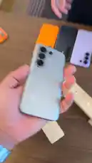 Watch a hands-on durability test of a new smartphone. A person demonstrates the phone's features before dropping it onto a wooden surface to see if the screen cracks. The video shows multiple phones on display, focusing on the drop test outcome. by @point_tech1 with Original Sound by point_tech1