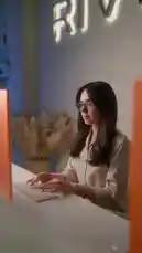 This video provides a behind-the-scenes look at the Revive body reshaping treatment process. It begins with a woman researching the best device for body reshaping online. She then enters a dark room where a Revive machine emits blue light. The video concludes with a close-up of the Revive device's screen, which displays the brand name. by @rivive.sa with Original Sound by rivive.sa