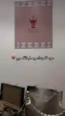 This video features Noura showcasing a luxurious collection of Oud Al Adad incense burners, oud wood, and perfumes. Viewers see intricately designed silver and gold burners emitting fragrant smoke, elegant green wooden boxes filled with dark oud chips, and clear perfume bottles labeled H1, H2, and H3. The setting includes traditional Arabic patterns, a striking black horse artwork, and branded pink shopping bags, creating an authentic and inviting atmosphere for those interested in Middle Eastern fragrances and home ambiance. by @vg.lens with vg.lens by Original Sound