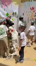 Watch joyful children at 'Step by Step' child care center wearing protective caps as they engage in a creative painting activity. They splash colorful paint on large paper sheets and walls, showcasing their artwork and having fun together. by @stepbystepkh with Original Sound by stepbystepkh
