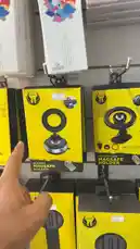 A Simple Store employee showcases their new inventory of phone holders. The video highlights a 'Modern MagSafe Holder' with a circular design and a 'Vacuum Absorption Magnetic Bracket' with a long shaft, both displayed in bright yellow packaging. The employee points out the different models available, including one with a suction cup base, emphasizing the variety of options for mounting phones. by @power.ch01 with Original Sound by power.ch01