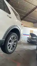 A tour inside a bustling auto repair shop, featuring a black Nissan SUV with its hood open for service. In the background, another vehicle is elevated on a lift, showcasing a typical day of car maintenance and repairs. by @hawkar_service with Original Sound by hawkar_service