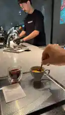 This video provides a close-up, step-by-step demonstration of brewing a pour-over coffee. A barista prepares the coffee grounds while the viewer sees the final cup being stirred. It's a perfect guide for anyone looking to learn the basics of making specialty coffee. by @alysf90 with Original Sound by alysf90