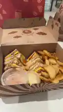 In this short clip, food enthusiast Bader Alodah presents his 'Box of Love,' showcasing a mouthwatering club sandwich with crispy potato wedges and dipping sauces. The meal is served in branded packaging from 'Pho Saudi,' setting the stage for a delightful culinary experience. by @guruofmarketing with Original Sound by guruofmarketing