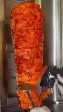 This video provides a behind-the-scenes look at how shawarma is prepared and served at the restaurant الرمــــــــال-restaurant ⚓️. It starts with the roasting of the meat on a vertical spit, followed by slicing it thinly. The video then shows the assembly of mini pizzas and the preparation of a classic shawarma platter with fries, sauces, and fresh vegetables. Finally, the delicious meal is enjoyed at a table, showcasing the perfect combination of flavors. by @sandshawarma with Original Sound by Contains: Reflections on 52nd - AGM3